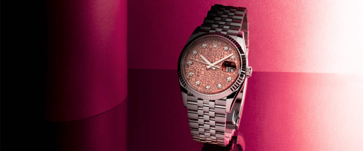 luxury diamond watch on pink background